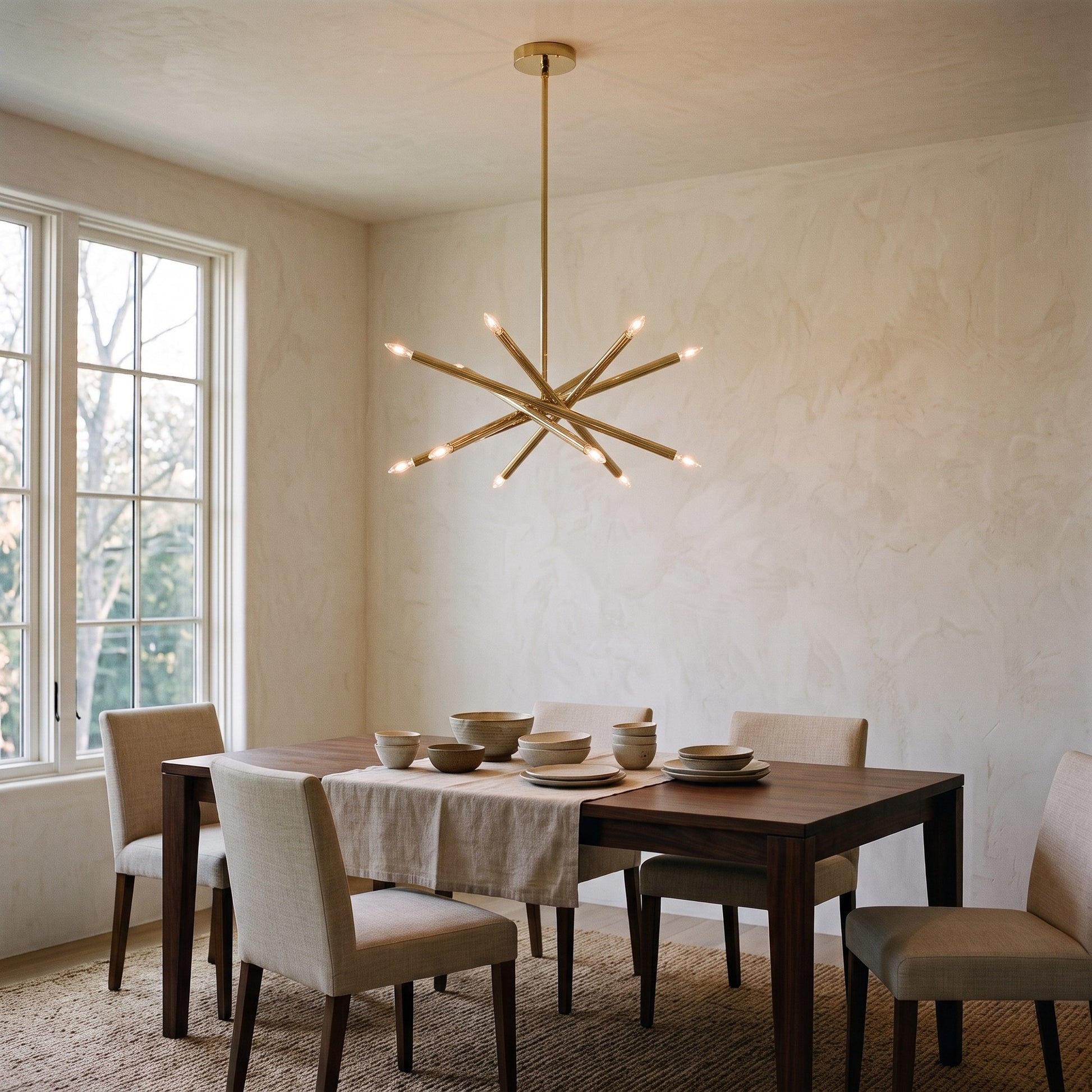 12-Light Stilnovo Chandelier – Handmade Raw Brass Ceiling Lamp in Polished Brass, shown installed in a dining room