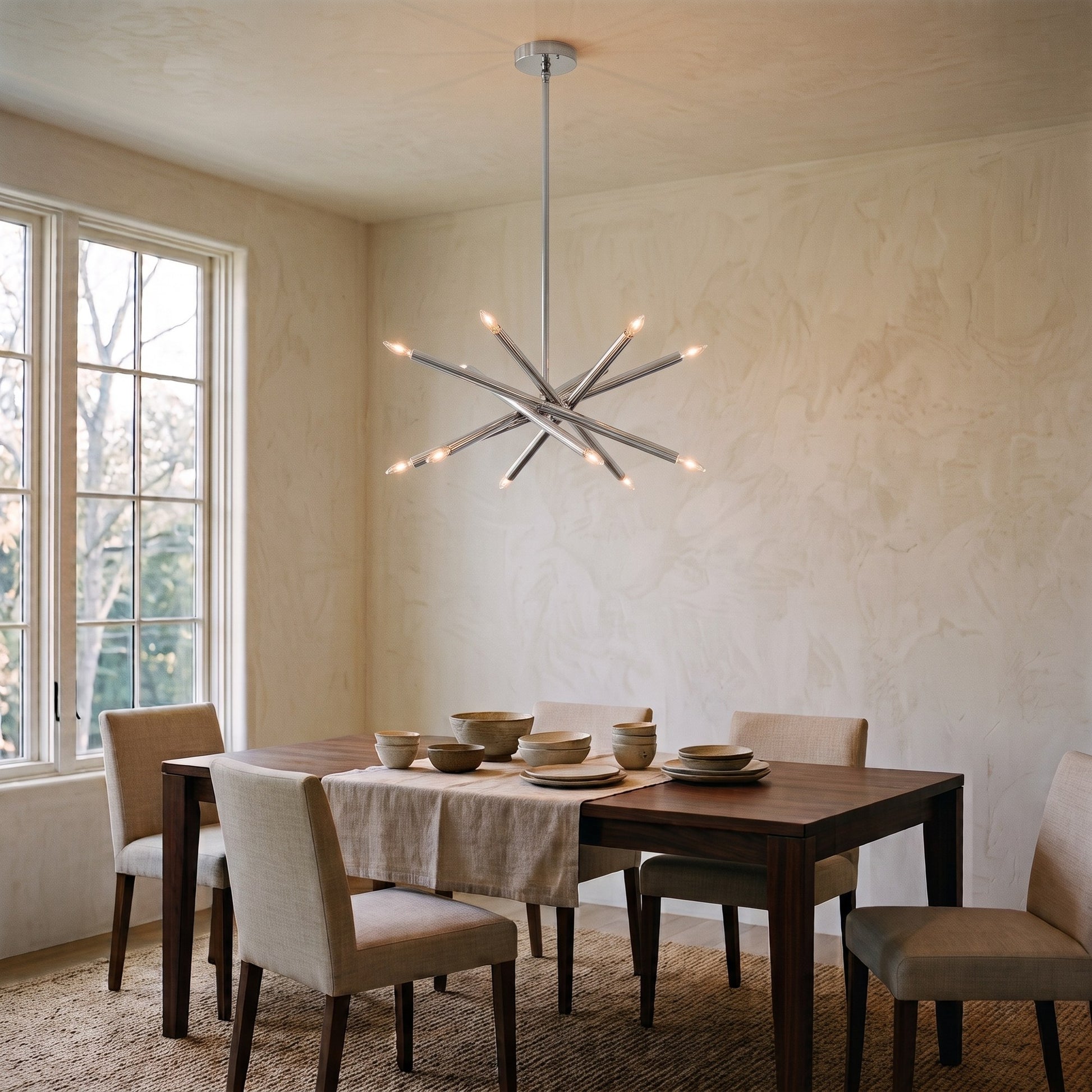 12-Light Stilnovo Chandelier – Handmade Raw Brass Ceiling Lamp in Polished Chrome, shown installed in a dining room