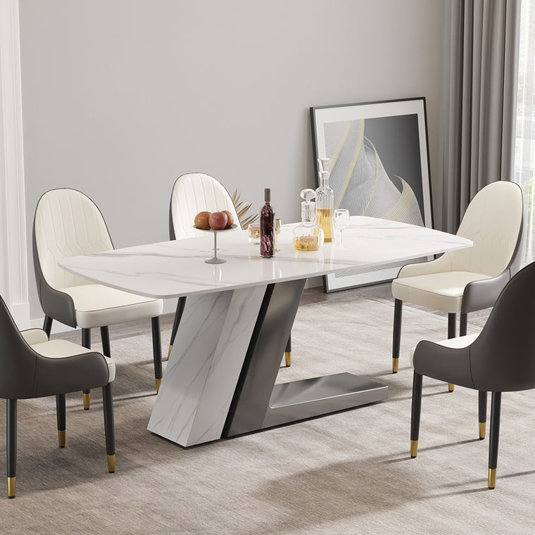 Linea dining table with a marble effect top on a sculpted pedestal base, in a dining room