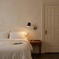 Articulated One-Light Wall Lamp – Mid-Century Modern Brass Sconce in a room