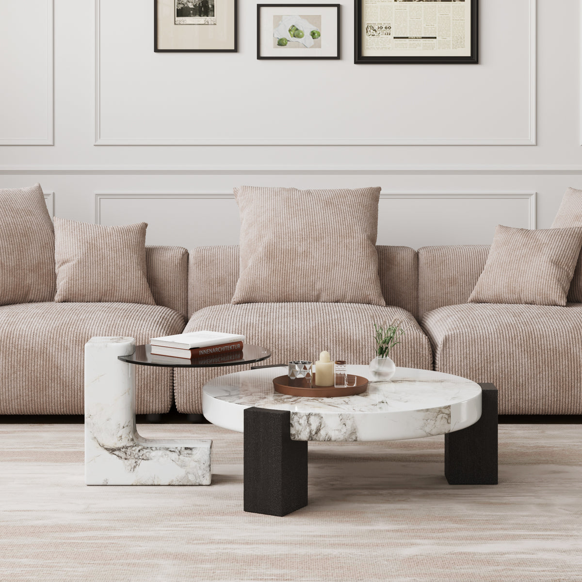 Living room with a corduroy sofa, marble-topped Leon coffee table and framed prints