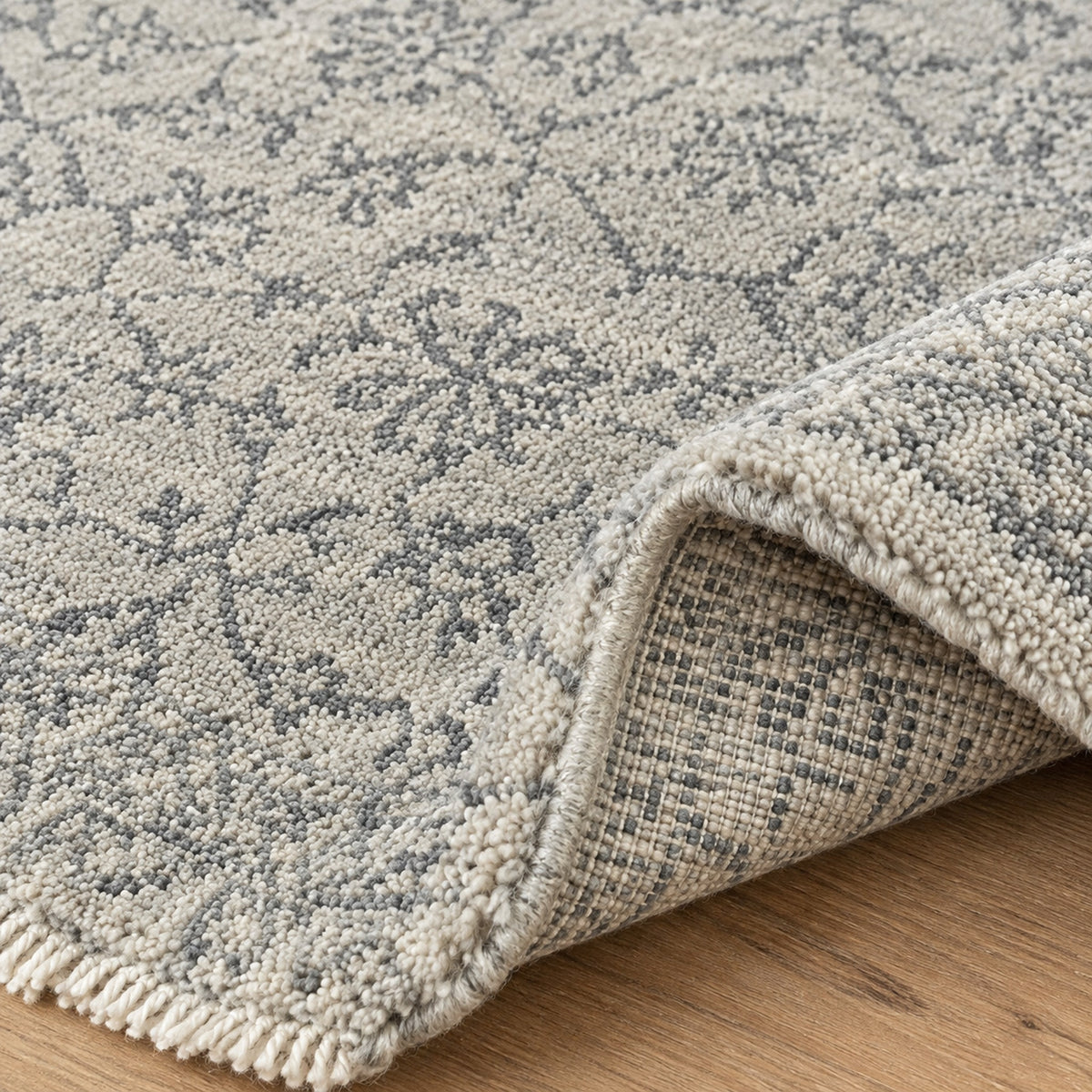 Gray Silver Floral Traditional Faded Color Hand Knotted Rug, folded corner showing the back