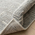Irradiant Ivory Charcoal Rug, folded corner showing the back