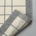 Ivory Grey Hand Loom Rug, folded corner showing the back