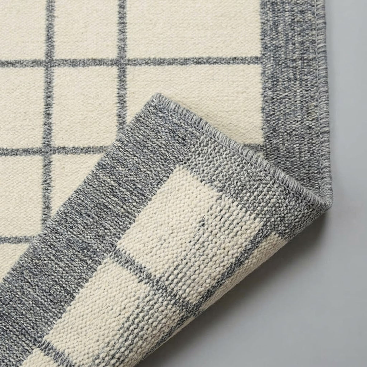 Ivory Grey Hand Loom Rug, folded corner showing the back