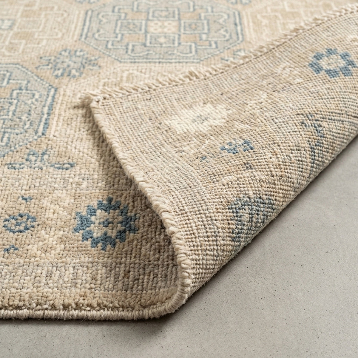 Khotan Faded Ivory Turkish Hand knotted Rug, folded corner showing the back