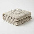Linear ivory striped rug, folded corner showing the back