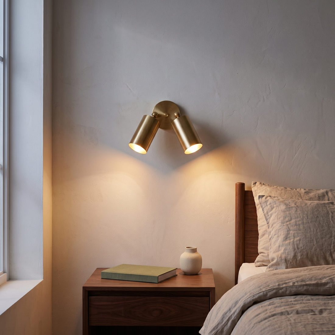 Mid-Century Wall Sconce, 1950s Italian style brass twin-spot light fixture in Polished Brass, on a white background