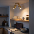 Mid-Century Wall Sconce, 1950s Italian style brass twin-spot light fixture in Polished Brass, ceiling mounted in a kitchen, both heads lighting an open oak shelf and the worktop below