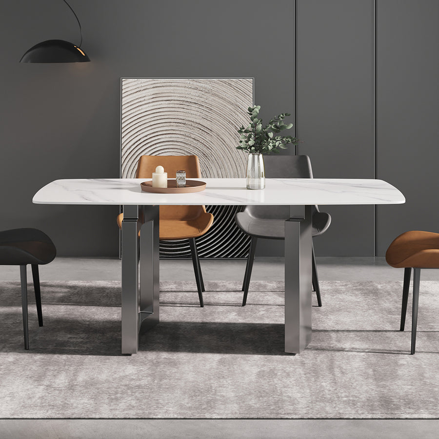 Maison dining table with a white stone top on two splayed grey steel legs, set in a dining room