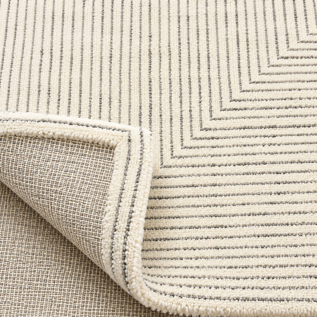 Stripe exquisite rug, folded corner showing the back