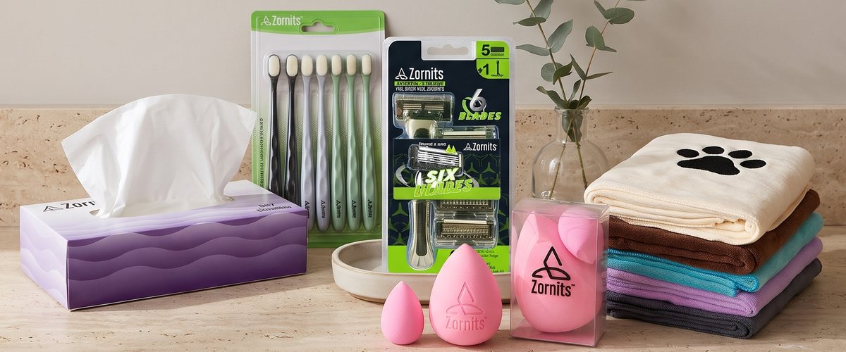 Zornits tissues, toothbrushes, razor, beauty sponges and dog towels on a stone counter