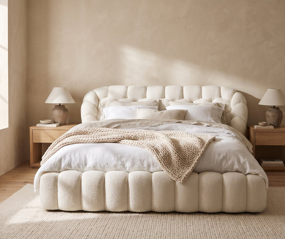 Cream tufted boucle bed in a sand bedroom